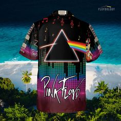 a shirt with the pink floyd logo and music notes on it, in front of an ocean view