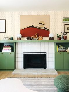 a living room filled with furniture and a fire place in front of a painting on the wall