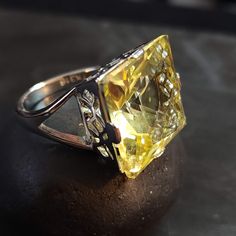 Stainless Steel ring with a split ring band and large 18mm pale yellow cubic zirconia (CZ) stone. ◄ FEATURES ► * Silver ring size 7 * Metal stamp says TK316 (steel) * Statement ring. High quality. Lots of sparkle. * The Topaz/Citrine CZ is 18mm. * The front of the ring is 10 tall. * The ring band is 2.5mm wide at the back. For size reference: * a U.S. penny is 19.05mm diameter.  * a U.S. nickel is 21.21mm diameter.  * a U.S. quarter is 24.26mm diameter.  ◄ HOW TO CARE FOR CZ JEWELRY ► 1. Keep it clean. Clean your CZ jewelry regularly to maintain its luster and shine. Use a soft-bristled brush or a soft cloth to gently wipe away dirt, dust and grime. 2. Store it safely. When not in use, store your CZ jewelry in a safe place, such as a jewelry box or a cloth pouch. Keep it away from other je Luxury Yellow Topaz Ring With Diamond Accents, Formal Yellow Topaz Ring With Diamond Accents, Elegant Yellow Diamond Ring Hallmarked, Hallmarked Yellow Diamond Ring, Classic Citrine Jewelry With Diamond Accents, Formal Citrine Diamond-cut Ring, Formal Citrine Ring With Diamond Cut, Formal Citrine Diamond Cut Ring, Elegant Yellow Rings With Diamond Accents