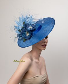 Love this hat shape, very chic! Cobalt blue derby hat made on a round straight sinamay shape, embellished with 2 silk organdy and velvet magnolias, silk satin band, blue goose and peacock feathers. Seated on a velvet headband. One size fit all. All my hats are hand made to order, please allow 1-2 weeks, if this is a rush order, please contact me before ordering. Hat comes with a pretty hat box for domestic orders only. International orders, hat will be packed nicely to protect it during the trip Kentucky Derby Structured Crown Boater Hat For Evening, Kentucky Derby Evening Boater Hat With Structured Crown, Blue Brimmed Mini Hats For Party, Chic Blue Fascinator For Races, Blue Structured Crown Hat For Spring, Blue Spring Hat With Structured Crown, Spring Blue Hat With Structured Crown, Chic Blue Party Hat, Chic Blue Mini Hat For Summer