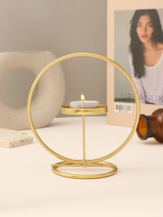 a candle holder on a table with a judge's gavel and photo in the background