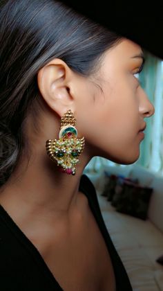 A very unique bold and elegant design! Amazingly elegant earring set that will elevate your outfits! Hand made and one-of-a-kind designed by our studio and finished by our artisans! Colored kundans with colorful beads on a beautiful shape earrings! A statement piece! Designer Tilla Earrings For Diwali, Gold Chandbalis With Tilla For Designer Wear, Designer Wear Festival Chandbalis, Fusion Style Kundan Pearl Earrings For Gift, Designer Temple Jewelry Chandbali Jhumkas, Elegant Chandbali Beaded Earrings For Festivals, Designer Temple Jewelry Jhumkas In Chandbali Style, Designer Chandbalis For Diwali, Traditional Designer Chandbalis