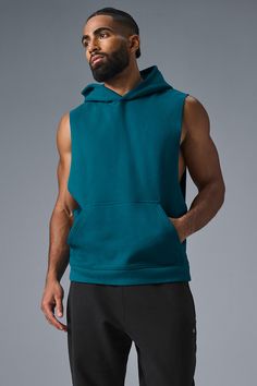 Stay cozy without sacrificing style in the Renown Sleeveless Hoodie. It has deep armholes, a kangaroo pocket, and a laid-back cut. And wait till you feel the Alo signature Renown fabric—it's smooth on the outside, a little fleecy on the side, and heavyweight for a just-right drape. Add shorts and you’re covered from the gym to the street. Athleisure Tops With Kangaroo Pocket For Streetwear, Casual Hooded Workout Vest, Casual Sleeveless Hoodie For Workout, Alo Yoga Hooded Top With Drawstring Hood, Sleeveless Cotton Hoodie For Loungewear, Athleisure Hoodie Top With Pockets, Hooded Top With Side Pockets For Streetwear, Stretch Hoodie Top With Pockets, Sporty Hoodie Tops With Pockets