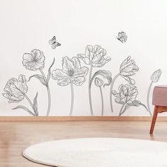 a living room with flowers and butterflies on the wall