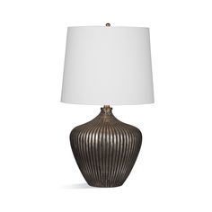 a table lamp with a white shade on it