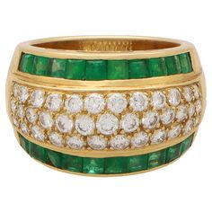 A beautiful vintage 1970's emerald and diamond bombe ring set in 18k yellow gold. The ring is composed in an iconic 70's bombe design, set centrally with a pave set diamond panel and bordered to each side with calibre cut emeralds. The design is subtle yet extremely effective and the ring looks fantastic once on the hand. Due to the design and size this ring could be worn for a variety of occasions. The piece could be worn by itself as a stand-alone piece, or alternatively stacked up amongst oth Bombe Ring, Domed Ring, Pretty Rings, Design Set, The Ring, Emerald Diamond, Ring Set, Ring Sets, 1970s