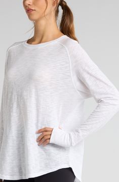 Work out or chill out in this breathable cotton top designed with sporty raglan sleeves and thumbhole cuffs. 29" length (size Medium) Crewneck Long sleeves with thumbhole cuffs 100% cotton Machine wash, tumble dry Imported Casual Long Sleeve Top With Thumbholes For Loungewear, Everyday Athleisure Tops With Thumbholes, Spring Crew Neck Long Sleeve Top For Workout, Casual Crew Neck Activewear With Thumbholes, Casual Activewear With Thumbholes And Crew Neck, Casual Long Sleeve Crew Neck Top With Thumbholes, White Raglan Sleeve Athleisure Top, White Raglan Sleeve Tops For Athleisure, Casual Activewear With Thumbholes