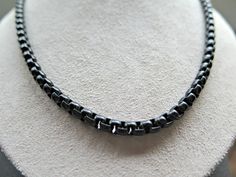 This 5mm black box chain necklace is created with a modern box chain link in anodized steel. The links are curved so this is a softer edge compared to a square box chain. Shown on the model who wears size large in a 20 inch length. The unsoldered box links sit easily when worn. I have completed the necklace with matching links and a lobster clasp, all in anodized black steel. To choose the correct necklace length for you, please refer to the sizing photos or the Etsy size guide. The model in the grey shirt wears a men's size medium. The necklace shown is 3mm wide, slightly thicker than the necklace in this listing. Please contact me with any other questions. Additional modern artisan jewelry can be found in my shop here: http://www.etsy.com/shop/Splurge?ref=si_shop Black Box Chain Link Necklace, Black Jewelry With Rectangular Box Chain Links, Black Link Jewelry With Box Chain, Everyday Black Box Chain Necklace, Everyday Black Link Chain Necklace, Black Box Chain Necklace, Elegant Black Box Chain Necklace, Modern Black Necklace With Box Chain, Black Rectangular Chain Necklace