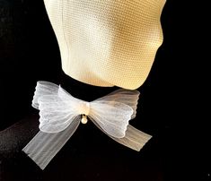 Flower bow choker is a trendy and chic accessory that adds a touch of elegance to any outfit. It can be worn with formal attire to enhance an elegant evening look or paired with casual outfits to add a touch of sophistication. Whether dressing up for a special event wedding, party..) or looking to elevate everyday wear, the organza choker with a bow offers a charming and eye-catching detail to complete the ensemble. Materials: velvet / organza Velvet choker: width: 20mm / 0.8 inches. Size: 29-36cm/ 11-14 inches adjustable length.  Closure: adjustable clasp Bow Size: 170x170mm / 7x7 inches.  Color: available in more colors  *Custom colors or sizing welcome - please message me prior to ordering. *Optional: matching bracelet, hair accessories, please write to create a unique set suitable for White Ribbon Bow For Spring, White Bow Tie Gift, White Bow Tie For Gifts, Chic Evening Bow For Spring, Chic White Wedding Bow, Chic White Satin Bow, Elegant Bow Tie With Butterfly Knot As Gift, Elegant Bow Tie With Detachable Bow As Gift, Chic Party Bow Tie With Ribbon