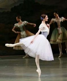 the ballerina is wearing a white tutu