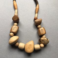 "This is a vintage necklace of handmade wood beads in a natural color. All beads are irregular in shape and from solid wood. it is created in the 70's. Length : approx. 34 cm / 13\" folded." Adjustable Brown Wooden Necklaces, Natural Wooden Beads Necklace, Nature-inspired Beaded Necklace With Wooden Beads, Nature-inspired Wooden Beaded Necklace, Adjustable Natural Wood Necklaces, Vintage Brown Beaded Necklace With Wooden Beads, Natural Wood Jewelry With Round Wooden Beads, Rustic Brown Hand-strung Necklaces, Natural Wooden Bohemian Jewelry