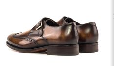 Experience the elegance of our Made in UK Monkstrap Shoes, a timeless blend of traditional English craftsmanship and modern style. Crafted with precision and care, these shoes are adorned with a stunning fire patina, making each pair a unique work of art. Key Features: Origin: Made in the UK, ensuring the highest standards of craftsmanship. Shipping: Your order will be meticulously crafted and shipped within 7-10 days after purchase. Materials: Fire patina leather, providing a distinctive and ca Elegant Brown Monk Strap Shoes With Rubber Sole, Timeless Monk Strap Shoes For Galas With Round Toe, Timeless Italian Monk Strap Shoes For Formal Occasions, Elegant Brown Goodyear Welted Monk Strap Shoes, Elegant Brown Monk Strap Shoes With Goodyear Welted, Elegant Italian Monk Strap Shoes For Formal Occasions, Elegant Brown Monk Strap Shoes, Luxury Formal Dress Shoes With Tang Buckle, Elegant Goodyear Welted Monk Strap Shoes