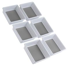 four white square trays with different sized compartments