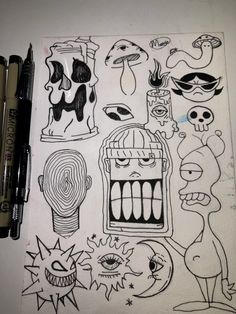 some drawings on a piece of paper with marker pens and markers in front of them