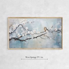 a bird sitting on top of a tree branch with white flowers