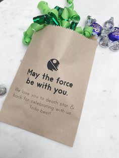 a bag with some candy on it sitting on a table next to other candies