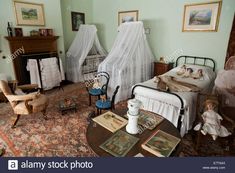 an old fashioned bedroom with antique furniture and pictures on the walls, including a baby's crib