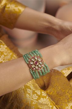 The sage green polki bracelet is a harmonious fusion of heritage and contemporary forms of Indian jewelry. The traditional red and green bracelet is handcrafted by the artisans of India to celebrate perfect armor between old and modern concepts. The beaded polki bracelet is a beautiful work of art with a royal touch to adorn your wrist and be a companion on your special days. Pair this statement piece with your Indian or contemporary ensemble and complete the look. Closure - Lobster. Style Tip - Green Fusion Bangle Bracelet, Green Fusion Style Bangle Bracelets, Fusion Green Bangle Bracelets, Green Bangle Bracelets In Fusion Style, Green Bracelet Jewelry For Celebration, Festive Green Handmade Bracelets, Festive Fusion Gemstone Bracelets, Festive Fusion Style Bracelets For Celebration, Festive Handmade Green Bracelets