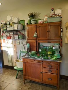 a kitchen with wooden cabinets and green dishes