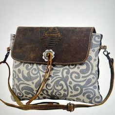 Includes leather flap to ensure safe storage. This crossbody bag also has a zipper at the back to accommodate small essentials. The Lacey leather design on front is sure to turn a few heads. materials: canvas, leather, hair on and rug Safe Storage, Gift Boutique, Leather Design, Canvas Leather, Book Gifts, Cross Body, Ivy, Crossbody Bag, Rug