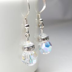 Drop crystal earrings are handmade with crystal clear faceted round crystal balls. Accented with a sparkly rhinestone crowns and offered on sterling silver or gold filled earring closures. Earrings are handmade with genuine Swarovski crystals - re-known for their fire and diamond like sparkle. A thoughtful gift for women born in April since diamond is her birthstone, or October since opal is hers.  Practical and wearable with everything in your closet. A great gift for your bridesmaids as a than Crystal Earrings Swarovski, Silver Bridesmaid, Bridal Party Jewelry, Blue Crystal Earrings, Peridot Crystal, Crystal Balls, Ball Bracelet, Popular Jewelry, Wedding Bridal Jewellery