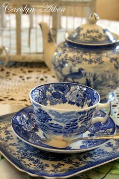 a blue and white tea set on a table