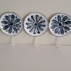 three decorative plates are hanging on the wall