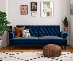 a living room with blue couches and pictures on the wall