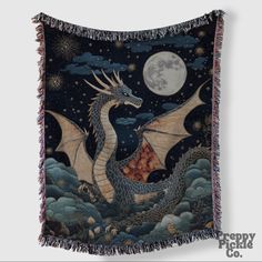 a tapestry with a dragon on it and the moon in the background