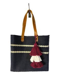 "Beautiful and one-of-a-kind tote handwoven by talented Mexican artisans in Oaxaca, Mexico.  Our unique totes are:  - Flexible, making it easy to fold without losing its shape - Easy to clean - Durable - Lightweight - Spacious - Environmentally friendly - 100% Leather Straps - Lined They are perfect for school, diaper bag, computer bag, and a unique perfect gift.   Material: high quality recycled plastic  * Pom Pom is included  It measures approximately: Height: 12\" Length: 13\" Width: 5.5\" Strap Drop: 9.5\" *Please double-check the size of your chosen bag to avoid an exchange. Size can vary since they are handmade artisanal products. *We do our best to ensure that our photos are as true to color as possible. However, due to inconsistencies in various monitors, lighting sources, digital Handwoven Tote Beach Bag For Everyday Use, Handwoven Tote For Everyday Use, Square Woven Bag For Everyday Use, Square Woven Bags For Everyday Use, Everyday Handwoven Tote Beach Bag, Rectangular Crochet Bag With Weaving Work, Artisan Tote Beach Bag For Everyday Use, Woven Tote Beach Bag For Travel, Artisan Handwoven Beach Bag