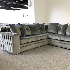 a large gray couch sitting on top of a carpeted floor