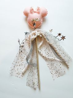 a pink teddy bear with stars on it's head