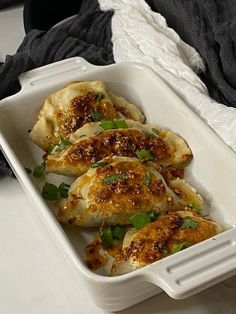 a white dish filled with food on top of a table