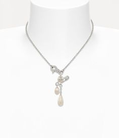 Crafted with silver-tone plating, the Claude Small necklace features a rounded pearl with a central orb, accented by a signature safety pin detail—a nod to Vivienne's punk-inspired, non-conformist style. A pearl drop and delicate chain details hang elegantly from the pendant, adding movement to the design, while the hardware-inspired clasp allows for an easy closure. Eastpak Backpack, Small Necklace, Punk Inspiration, Ring Watch, Delicate Chain, Safety Pin, Pearl Drop, Lace Boots, Vivienne Westwood