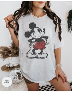 Step into the past with our "Inkwell Memories Mickey Tee." This vintage-inspired shirt captures the essence of classic Mickey Mouse in a sketch-style design. Embrace the nostalgia and show your love for the timeless charm of Disney's most iconic character. This tee is a must-have for any Disney enthusiast! *Unisex Sizing* Mickey Mouse Themed Crew Neck Shirt, Themed Cotton Shirt With Mickey Mouse, Retro Shirt With Character Print For Fans, Mickey Mouse Themed Cotton Top, Relaxed Fit Graphic T-shirt For Disney Fan Events, Relaxed Fit Graphic Print T-shirt For Disney Fan Events, Retro Short Sleeve Shirt With Character Print, Themed Mickey Mouse Cotton Top, Retro Cotton Shirt With Character Print