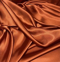 a close up view of an orange satin fabric