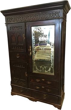 an old wooden armoire with glass doors