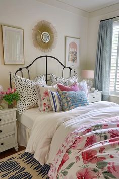 a bedroom with floral bedding and pink flowers on the comforter, pillows, and rugs