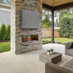 an outdoor fireplace in the middle of a patio