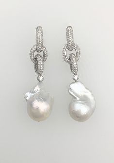 Stunning cultured freshwater Baroque pearls on an interlocking pavé rhodium plated chain.  Chain-link is available in 18K White-gold, 18K Rose-gold or 18K Yellow-gold plated over sterling silver.  PEARLS ARE 20-25mm; earrings are approx. 2 ¼" long.  Enhancer sold separately. Please note: Due to the unique and natural origin of pearls, slight variations may occur.  These characteristics enhance the beauty of the product and truly make them a one of a kind piece. Luxury Pearl Chain Sterling Silver Earrings, Elegant Sterling Silver Chain Earrings, Elegant Round Chain Earrings, Elegant Formal Earrings With Chain Detail, Elegant Chain Earrings For Formal Occasions, Luxury White Pearl Chain Earrings, Elegant White Chain Earrings, Luxury Pearl Chain Drop Earrings, Luxury Silver Earrings With Pearl Chain