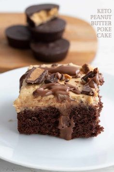 a piece of cake on a plate with chocolate cookies and peanut butter in the background