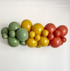 a row of different colored balloons sitting on top of each other