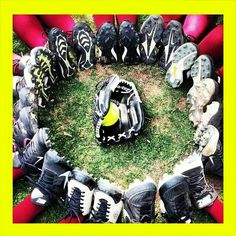 a group of baseball gloves and mitts are arranged in a circle on the grass