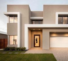 a modern house with two garages and three windows