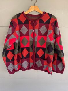 Cute vintage southwest look sweater cardigan.  No label.  fits like medium and maybe small. not sure of material.  colors of red, burnt orange, olive, gray, black and plum.  arm pit = 20.5 length = 22.5 Retro Crew Neck Cardigan For Fall, Red Fair Isle Pattern Cardigan For Fall, Red Fair Isle Cardigan For Fall, Vintage Multicolor Cardigan For Fall, Vintage Red Fall Sweater, Retro Fair Isle Pattern Cardigan For Fall, Retro Fair Isle Pattern Outerwear For Fall, Retro Fair Isle Cardigan For Fall, Retro Fair Isle Outerwear For Fall