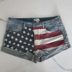 Purchased And Never Worn. 10.5” Inseam, About 16” Across The Waist Band When Laid Flat. Trendy Cotton Jeans For 4th Of July, Denim Shorts With American Flag Print For Spring, Denim American Flag Print Shorts For Spring, Trendy Spring Shorts With American Flag Print, Trendy Denim Shorts With American Flag Print, American Flag Print Denim Shorts For Spring, Trendy Spring Bottoms With Flag Print, American Flag Print Cotton Jean Shorts For Spring, Casual American Flag Print Shorts For Spring