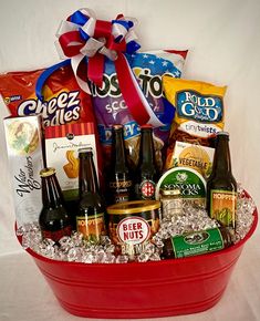 a red bucket filled with beer and snacks