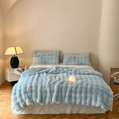 a bedroom with a bed covered in blue fur