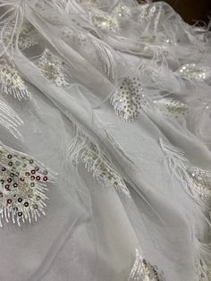 We offer a variety of fashion handmade fabric，those are widely use for wedding dress，garment and fashion cloth. we sell it by yard，our minimum order is 1 yards，and we always package it 15 yards for one roll，the width is 130cm/51 inch Material ： mesh ，Rayon,polyester. Symmetrical embroidery floral pattern, with lovely flowers in the middle, scalloped border. You can also cut and use separately. Perfect for dress, tops, wedding veil. You can split the piece up and have one scalloped edge around th Elegant 3d Embroidered Fabric For Party, Elegant Sequin Fabric For Spring Wedding, Elegant Sequin Tulle Fabric, Elegant Spring Wedding Sequin Fabric, White Embellished Tulle Fabric For Party, Elegant White Tulle Fabric For Party, Glamorous Summer Wedding Sequin Fabric, Elegant Embroidered Fabric With Sequins For Banquets, Elegant Sequin Fabric With Intricate Embroidery For Party