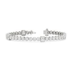 A sweeping sense of sophistication is deeply embedded within this tennis bracelet's timeless design. Bezel-set radiant and round diamonds line up to form a pattern, leading the eye from one flash of sparkle to another. Fastening the bracelet onto your wrist is a secure tongue-and-clip clasp. Classic Channel Set Diamond Bracelet, Luxury Diamond White Tennis Bracelet With Bezel Setting, Classic Bezel Setting Tennis Bracelet For Formal Occasions, Luxury Tennis Bracelet In Diamond White With Bezel Setting, Luxury Diamond Tennis Bracelet With Channel Set, Elegant White Gold Tennis Bracelet With Channel Set, Elegant White Gold Tennis Bracelet Channel Set, Classic Diamond Tennis Bracelet With Channel Set, Luxury Diamond Channel Set Tennis Bracelet